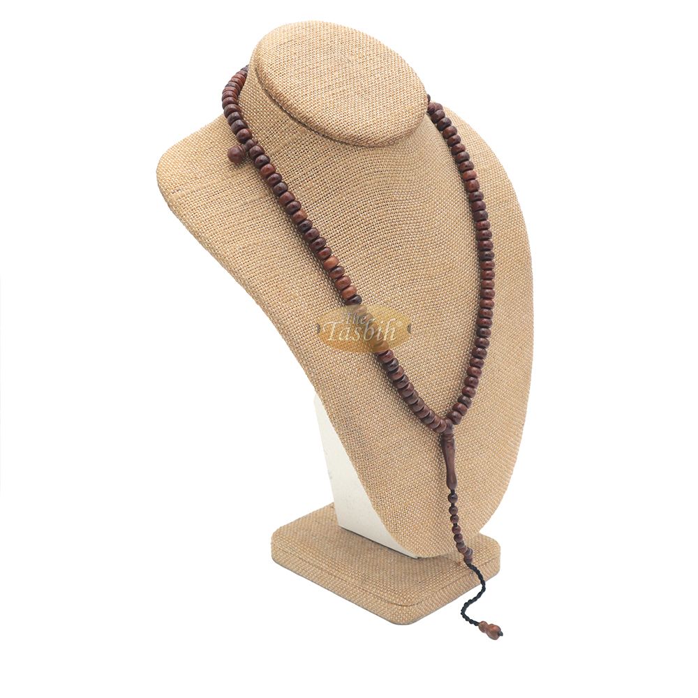 Brown wooden Islamic misbaha with rounded prayer beads and a black tassel cord.