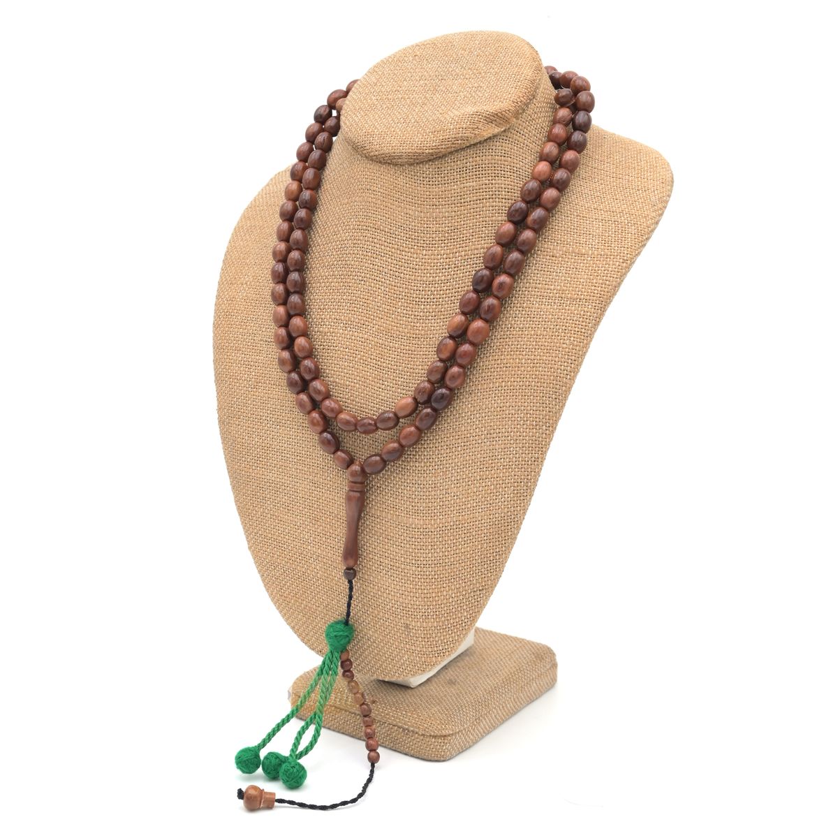 Brown wooden Islamic misbaha prayer beads with elongated oval beads and green tassels.