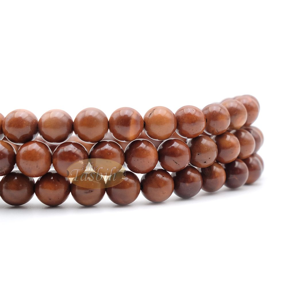 Brown wooden Islamic misbaha prayer beads with 99 beads and a black tassel cord.