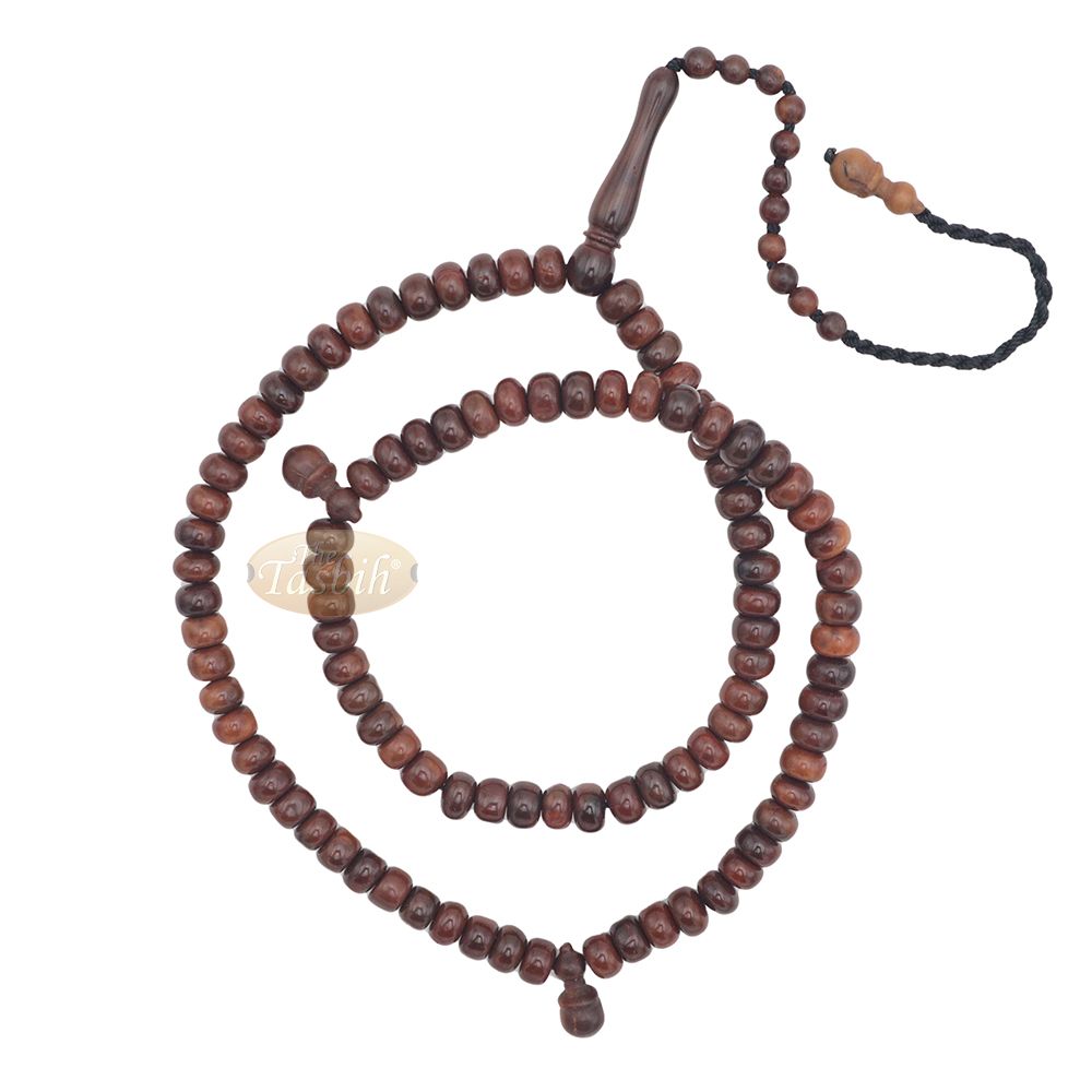Brown wooden Islamic misbaha with rounded prayer beads and a black tassel cord.