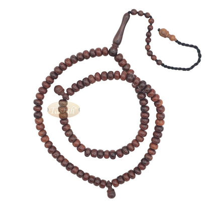 Brown wooden Islamic misbaha with rounded prayer beads and a black tassel cord.