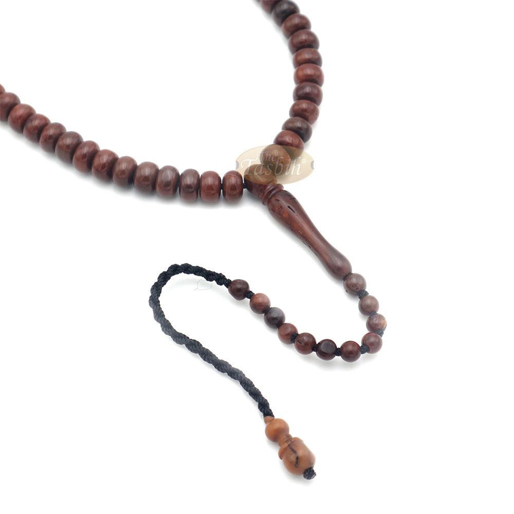 Brown wooden Islamic misbaha with rounded prayer beads and a black tassel cord.
