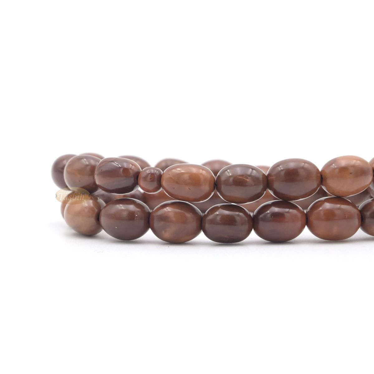Brown wooden Islamic misbaha prayer beads with elongated oval beads and green tassels.