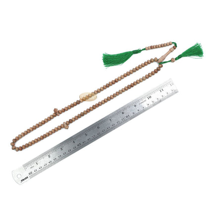 Wooden Islamic misbaha prayer beads with green tassels.