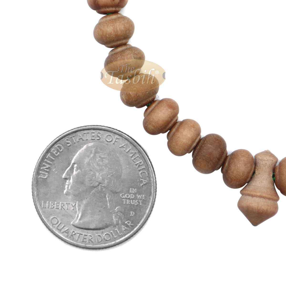 Wooden Islamic misbaha prayer beads with green tassels.