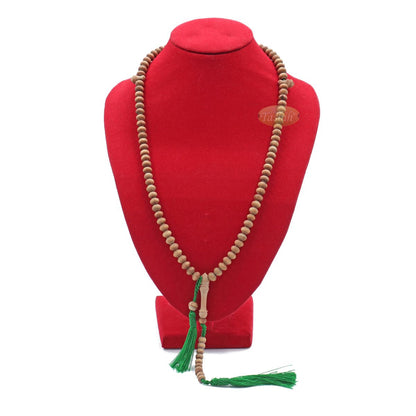 Wooden Islamic misbaha prayer beads with green tassels.